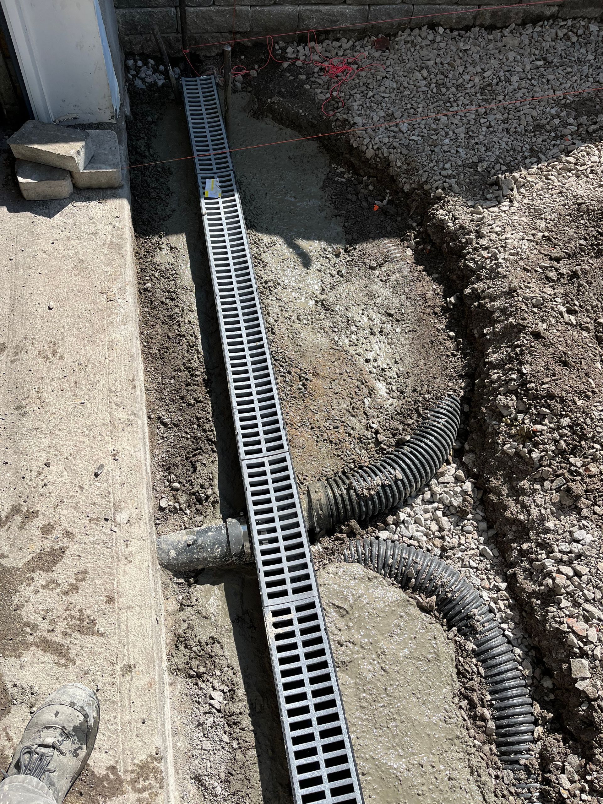 A drain is being installed in a hole in the ground.