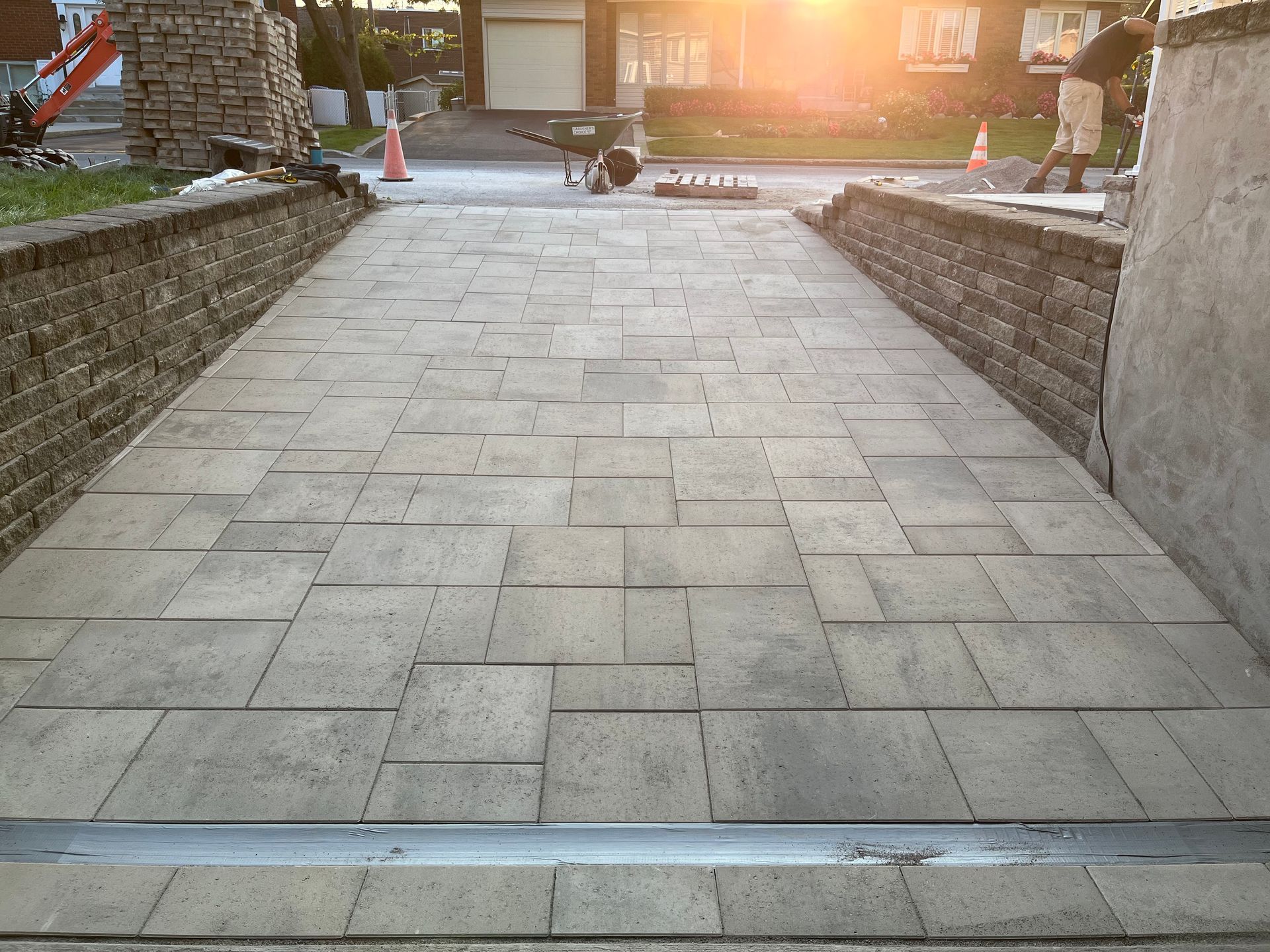A brick walkway is being built in front of a house
