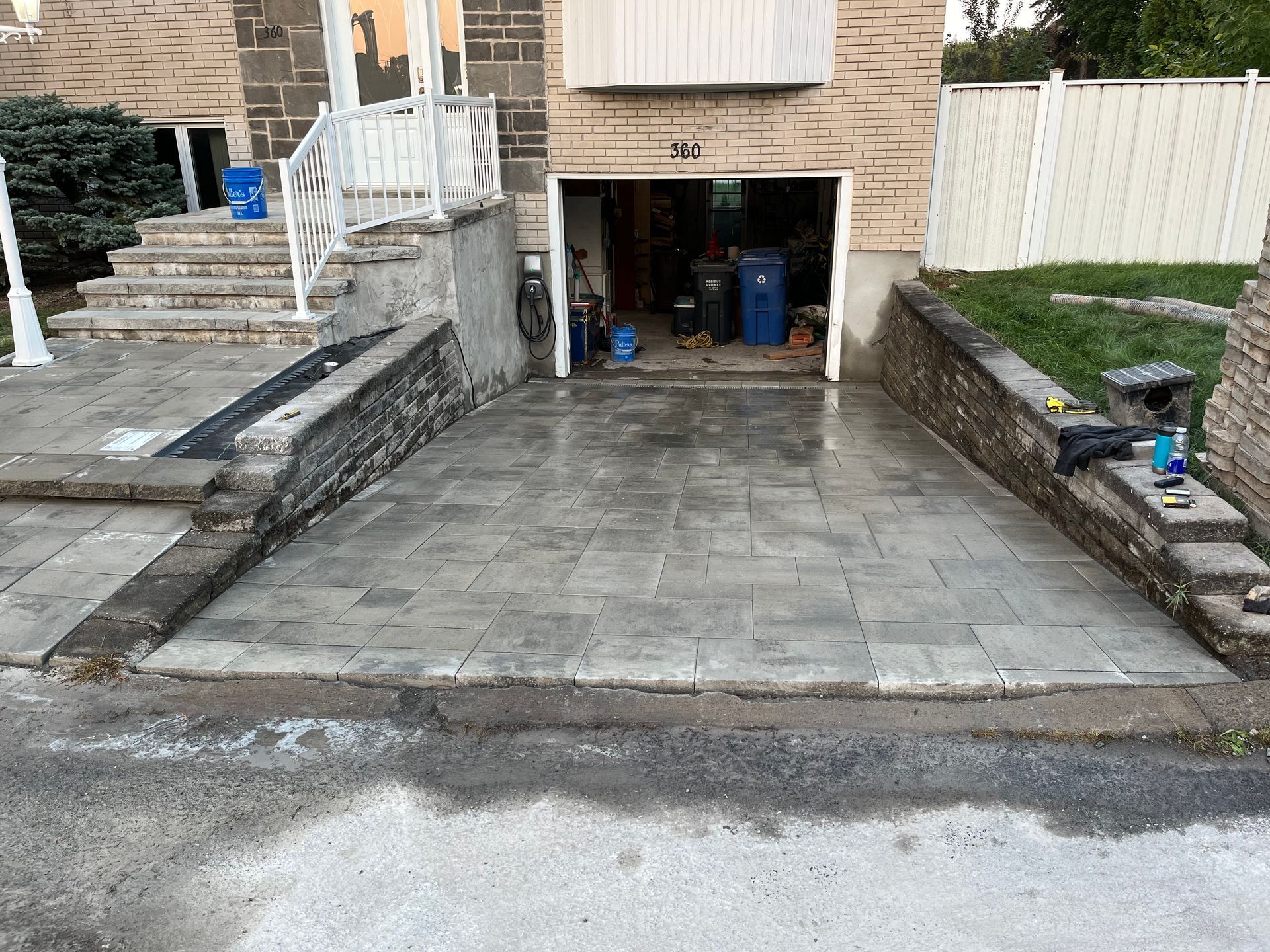 A driveway is being built in front of a house.