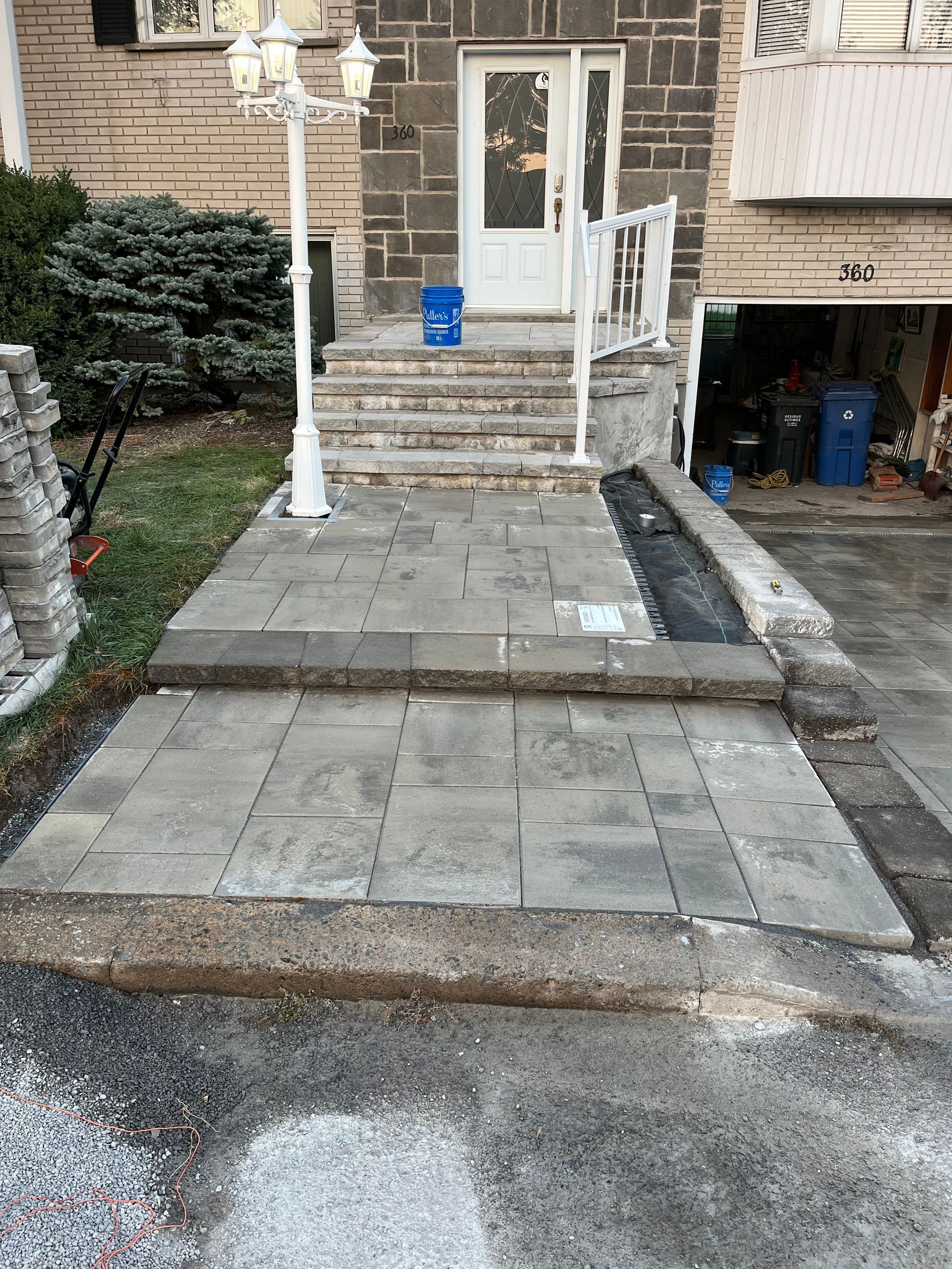 A stone walkway leading to the front door of a house.