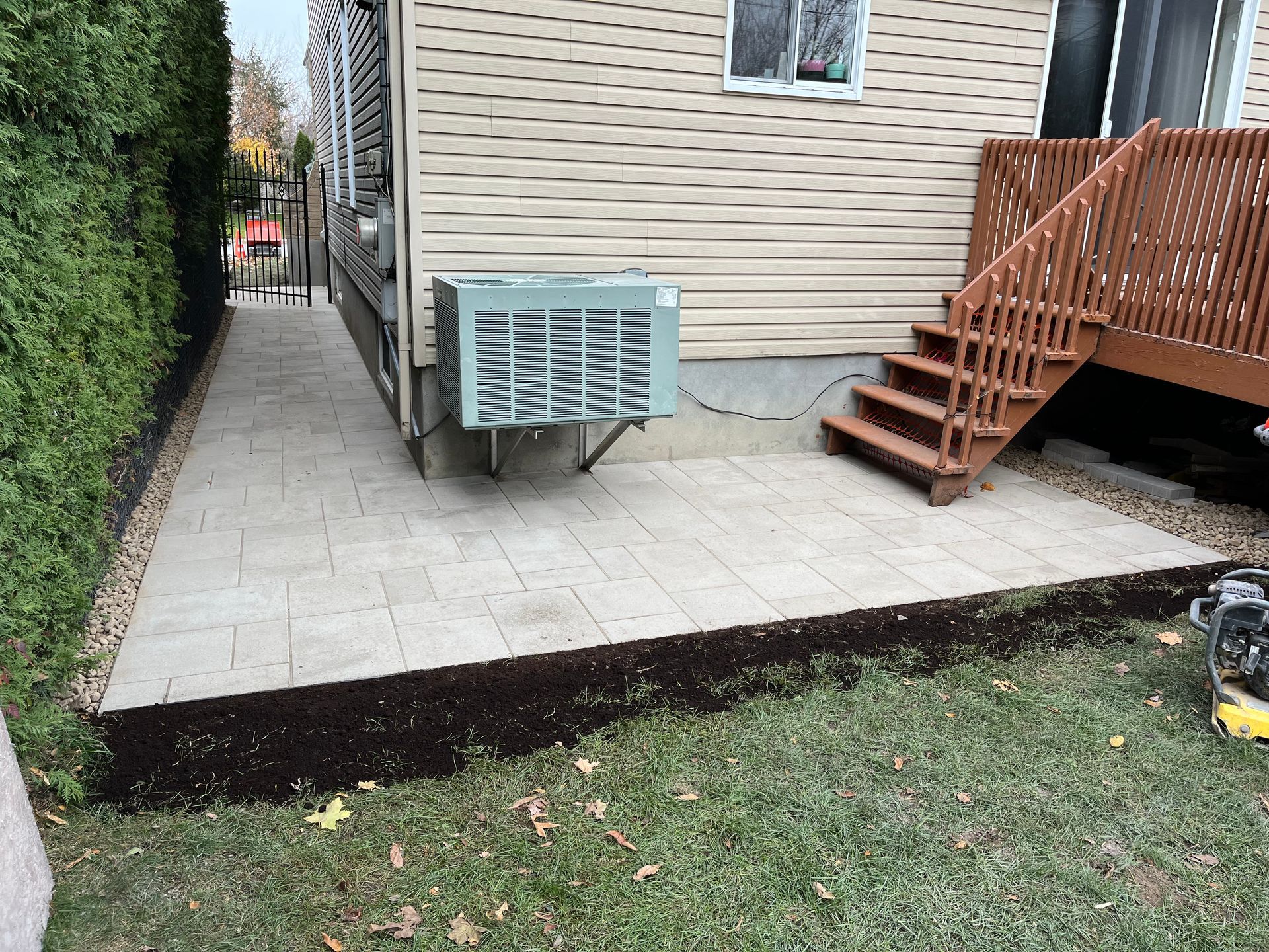 A house with a patio and stairs in front of it.