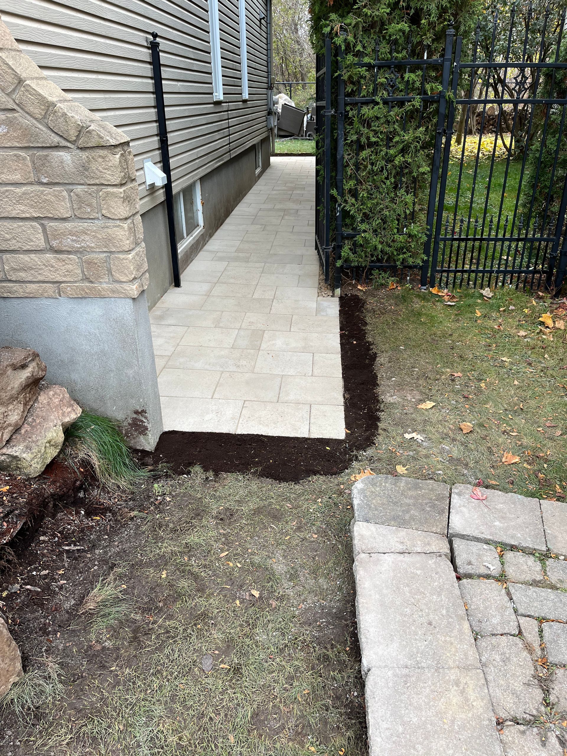 A sidewalk is being built in front of a house.