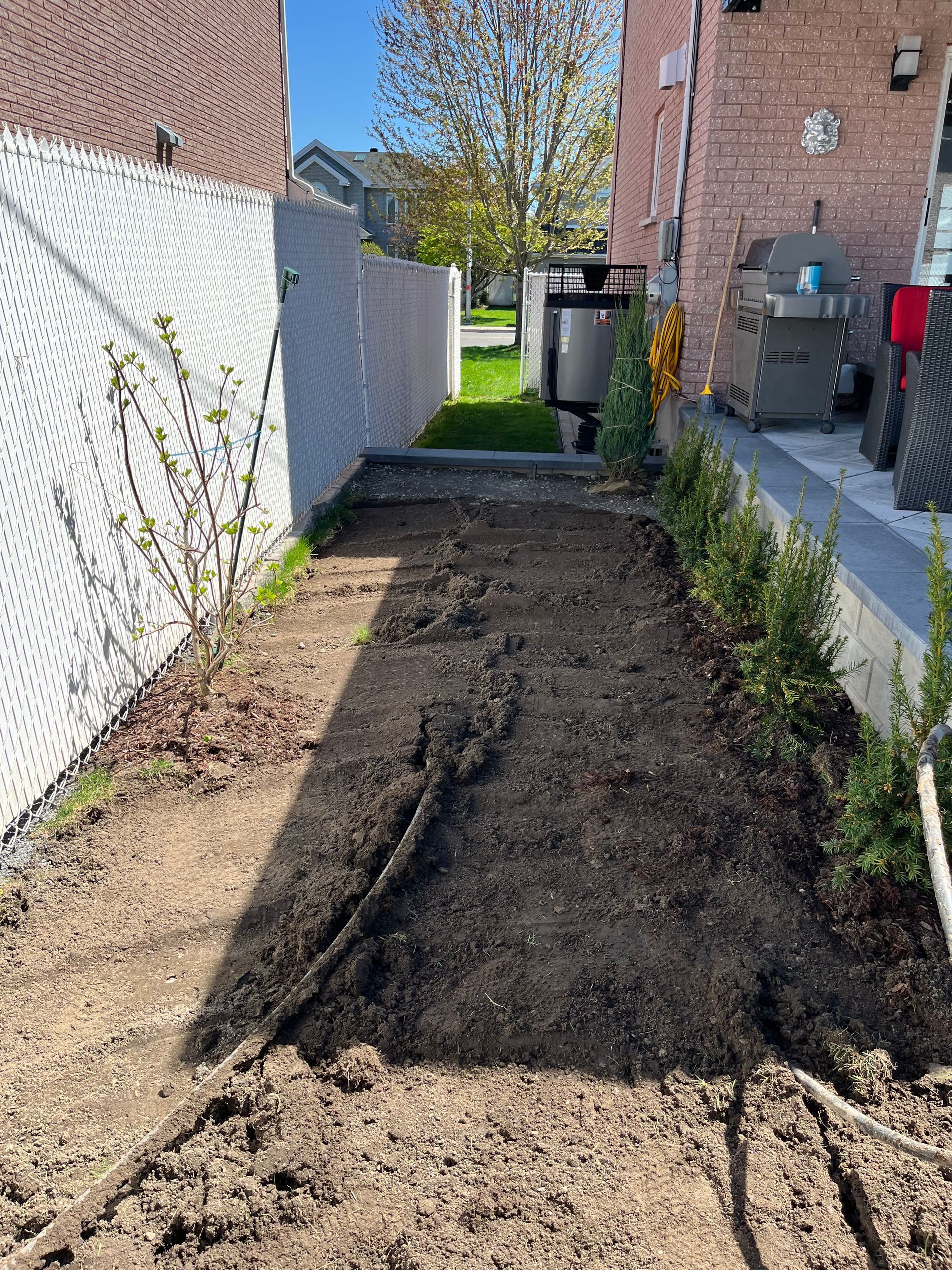 There is a lot of dirt in the backyard of a house.