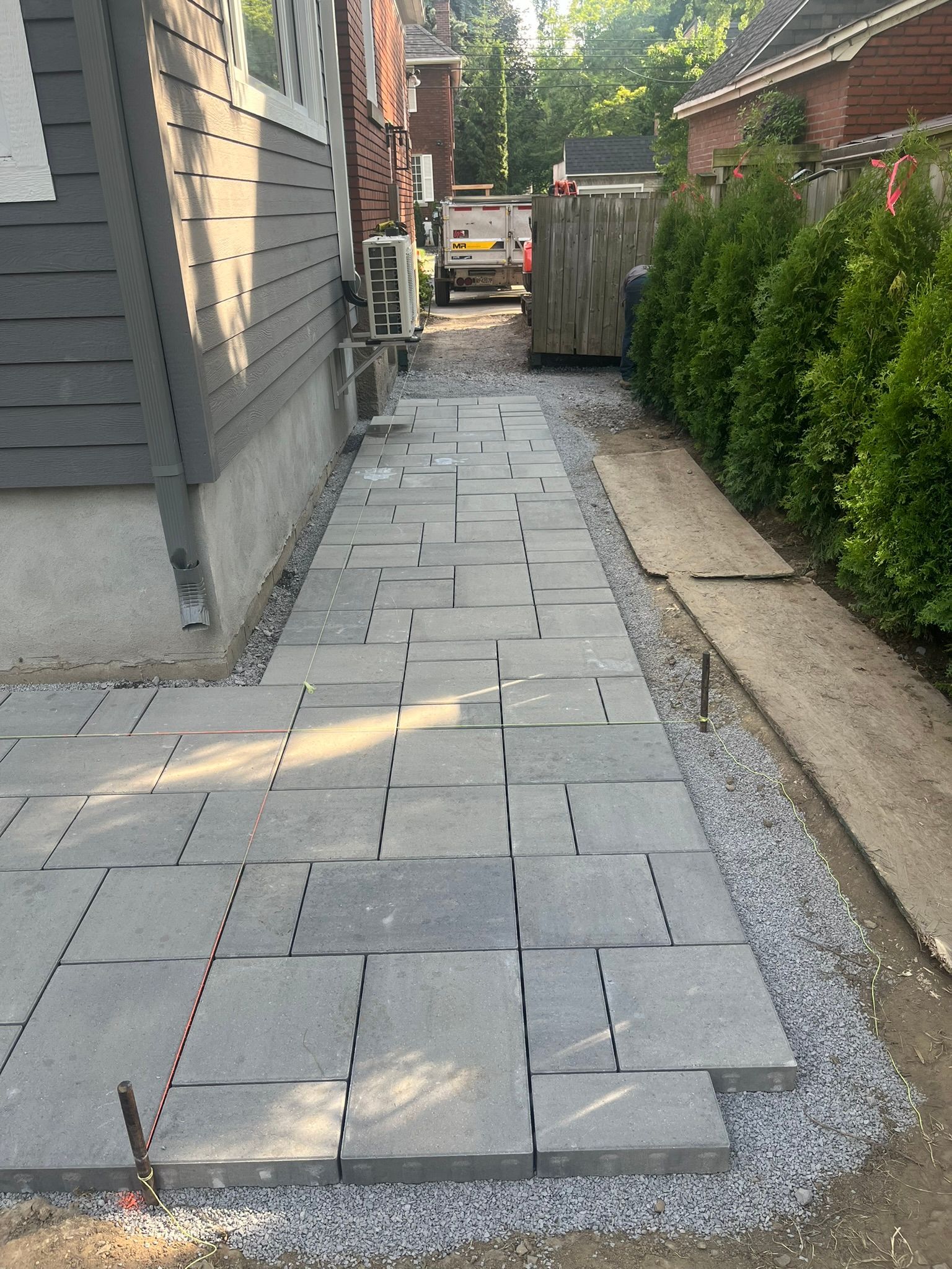 A sidewalk is being built in front of a house.