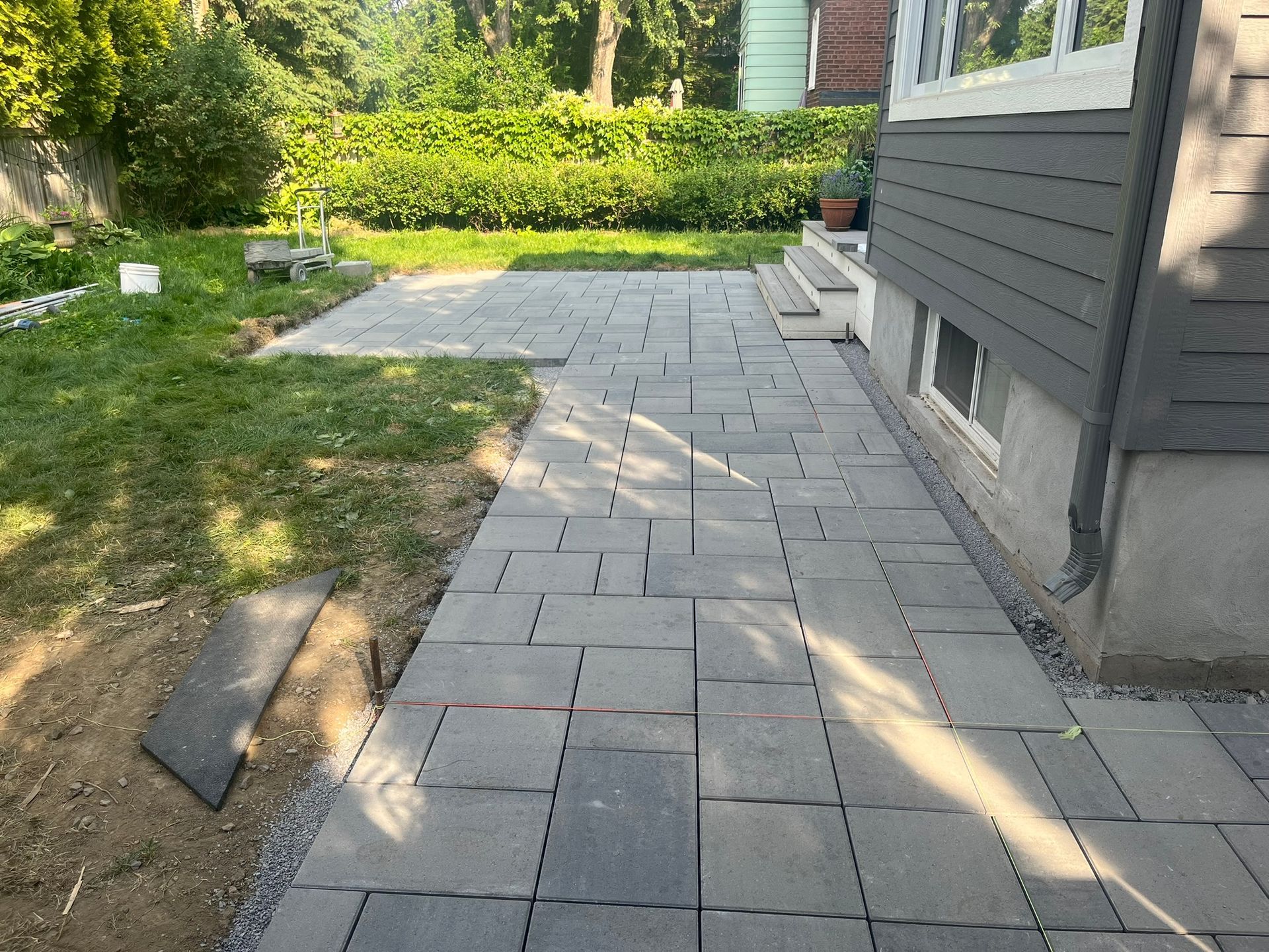 A sidewalk is being built in front of a house