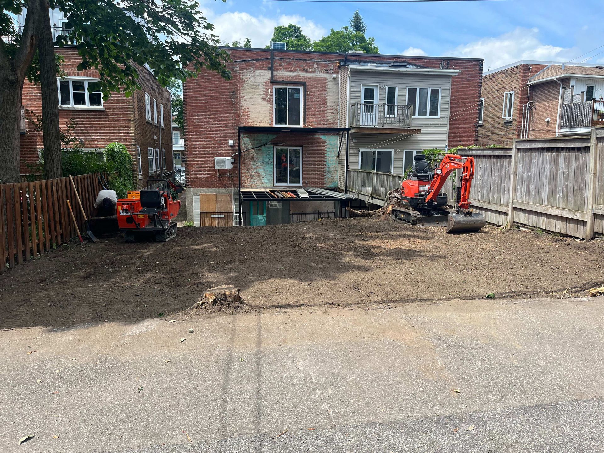 A construction site with a brick building in the background