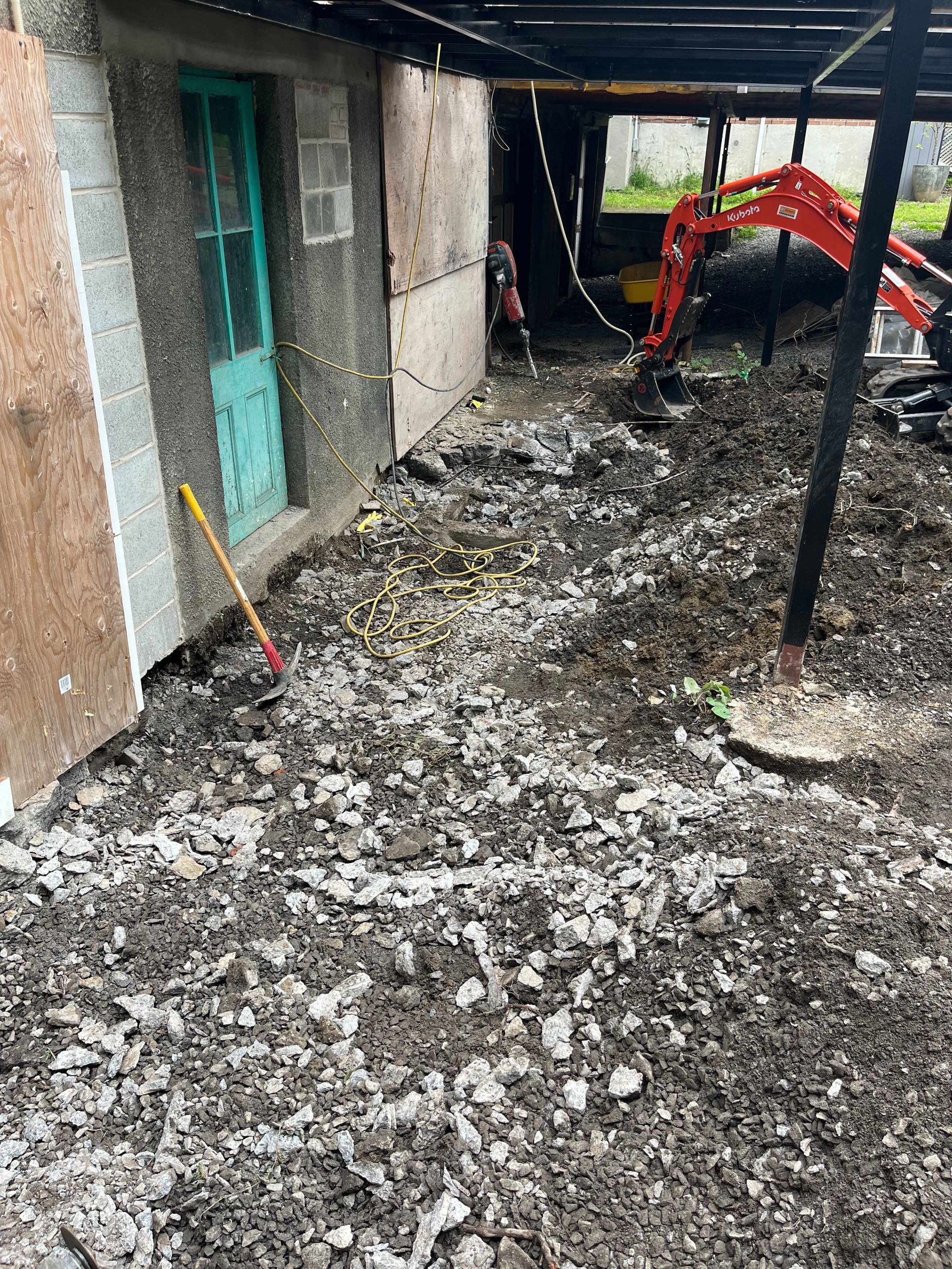 A large pile of dirt is sitting in front of a building.