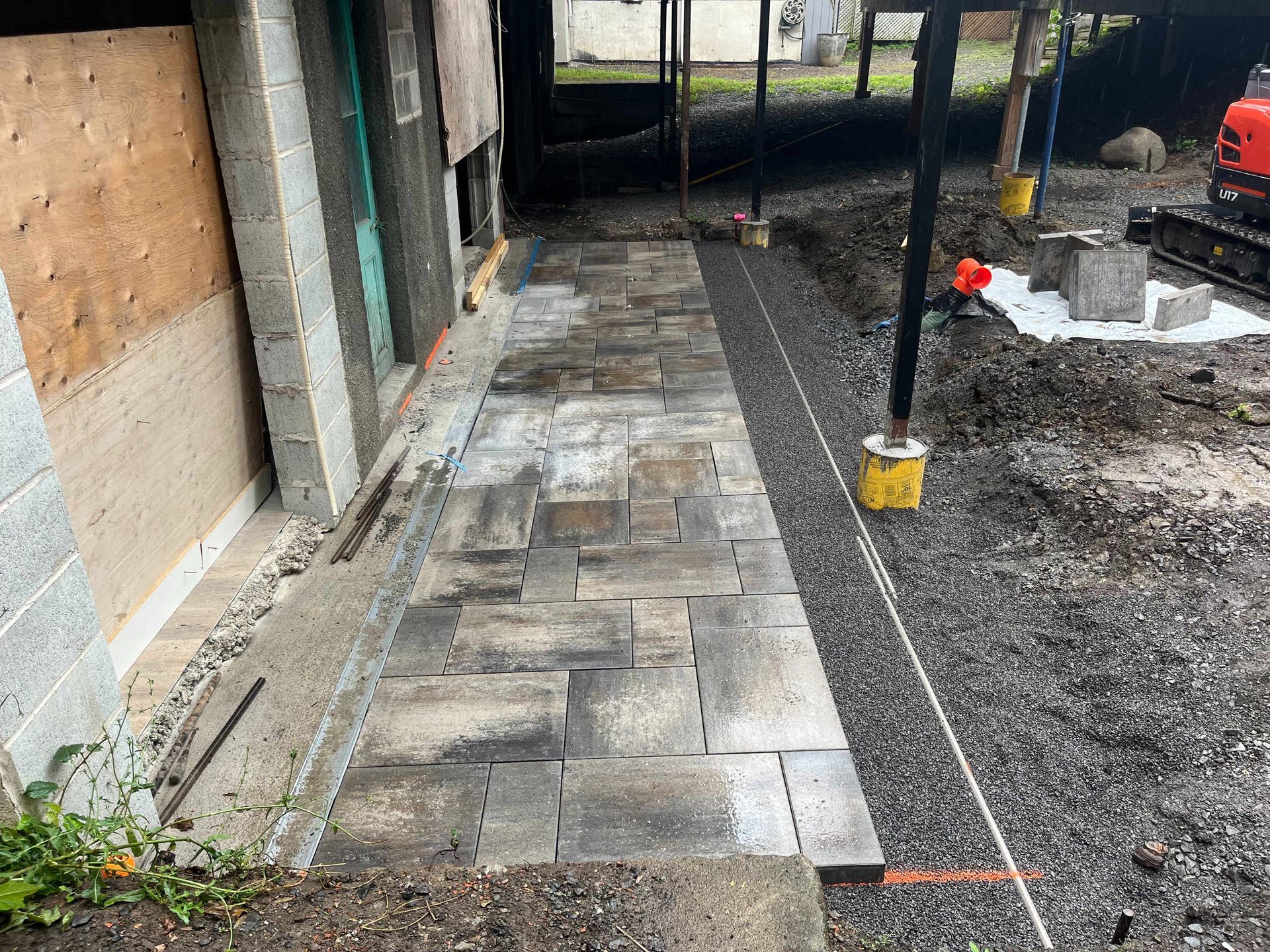 A sidewalk is being built in front of a house.
