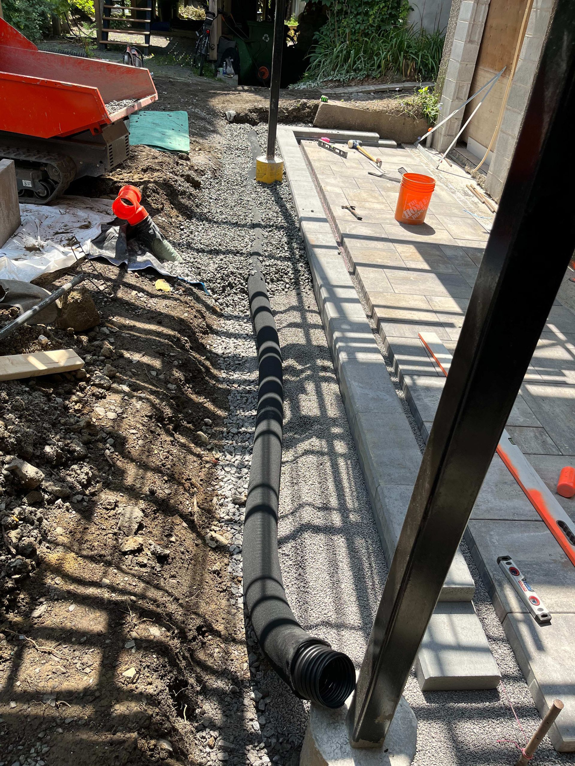 A pipe is laying in the dirt on a construction site.