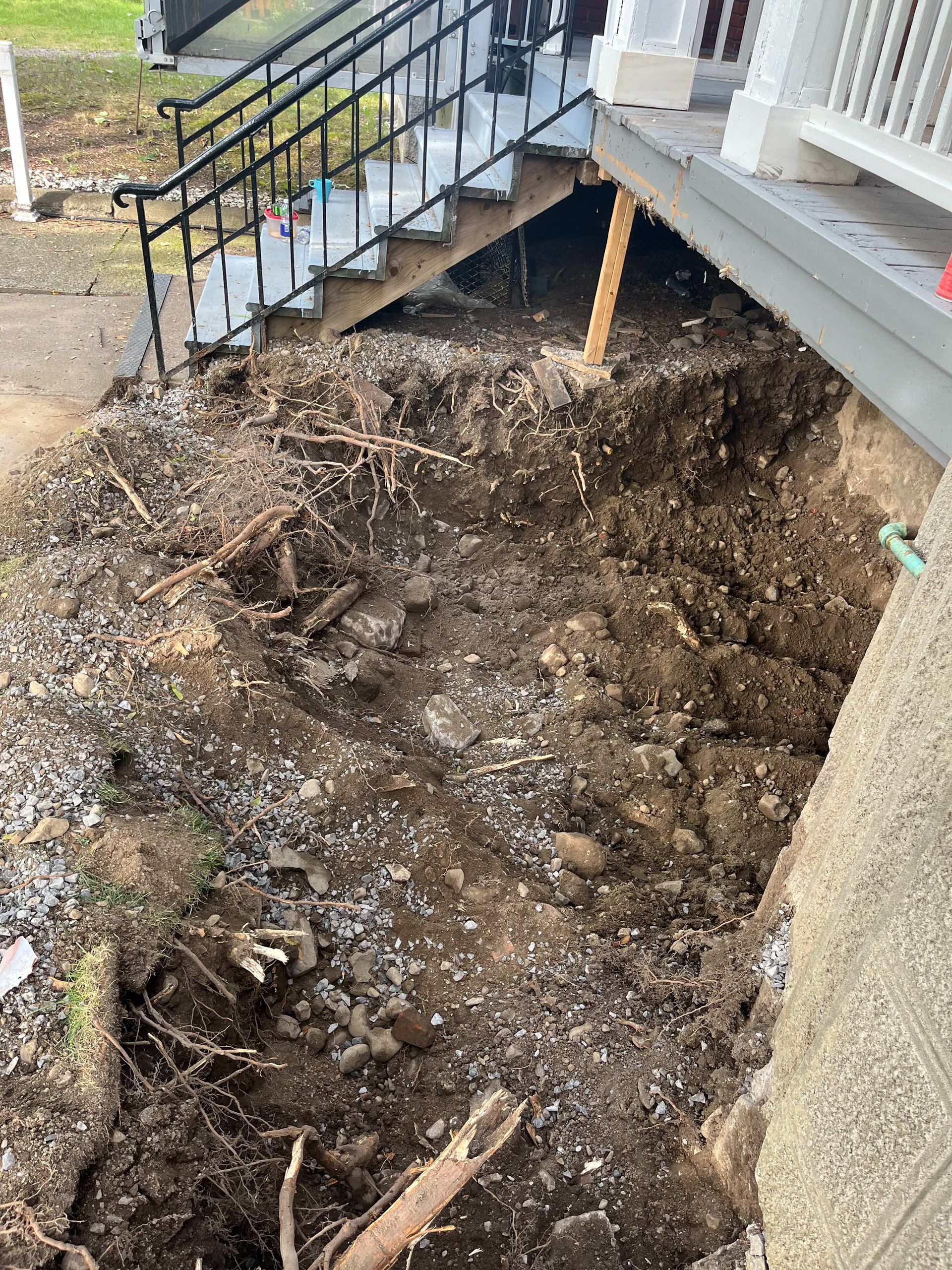 A pile of dirt is sitting next to a set of stairs.
