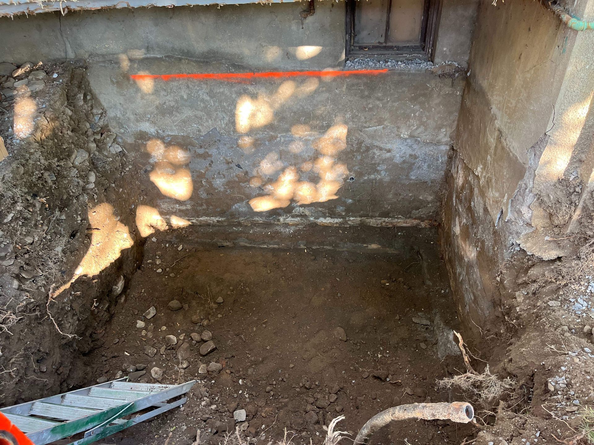 A hole in the ground with a shovel in it