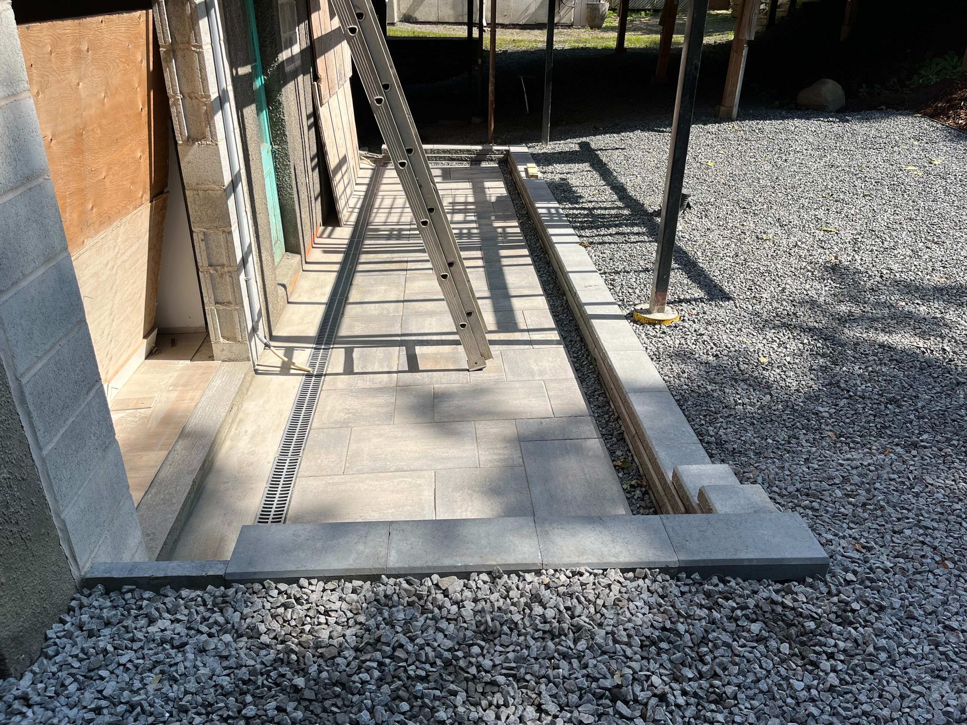 A ladder is sitting on top of a pile of gravel.