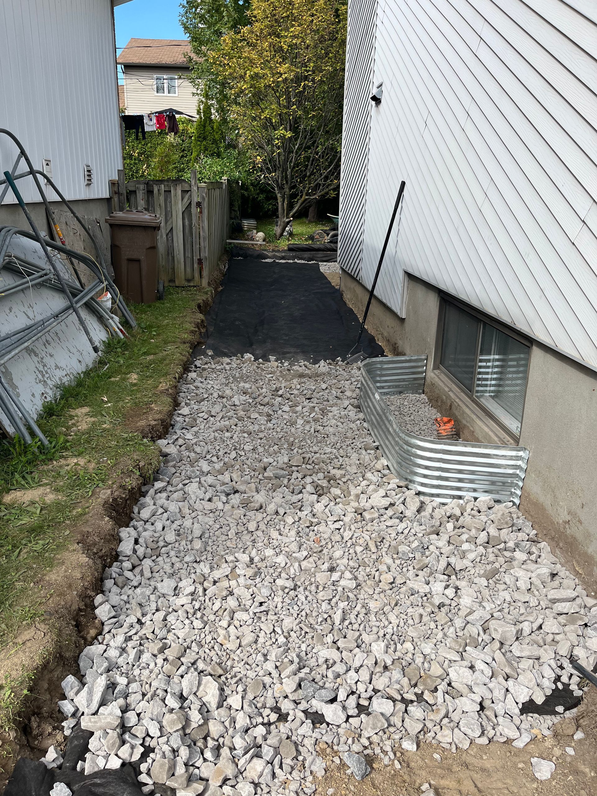 A gravel path is being built in front of a house.