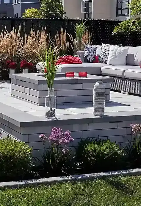 A patio with a couch and a vase of flowers