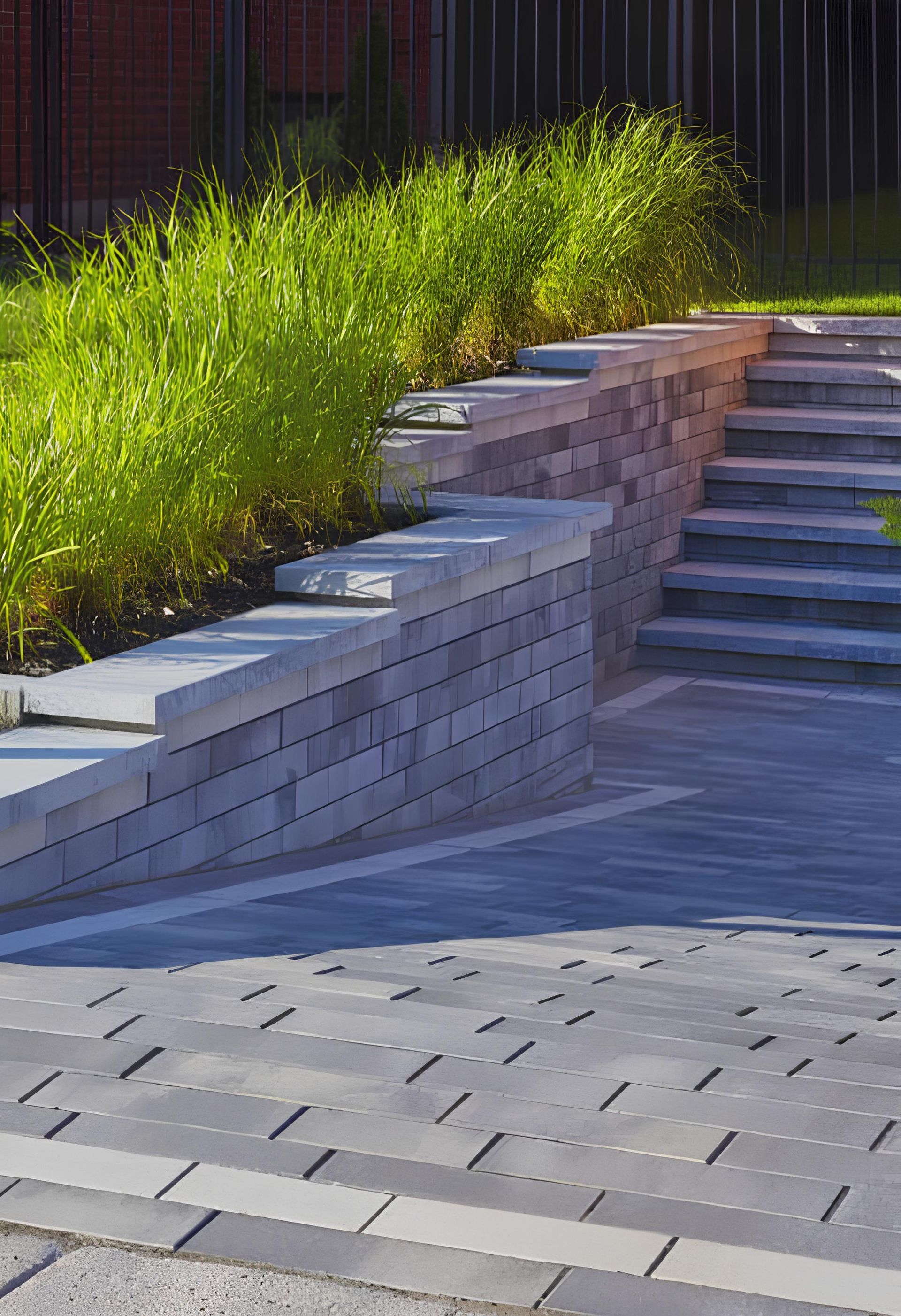 A brick wall with stairs leading up to it in a garden.