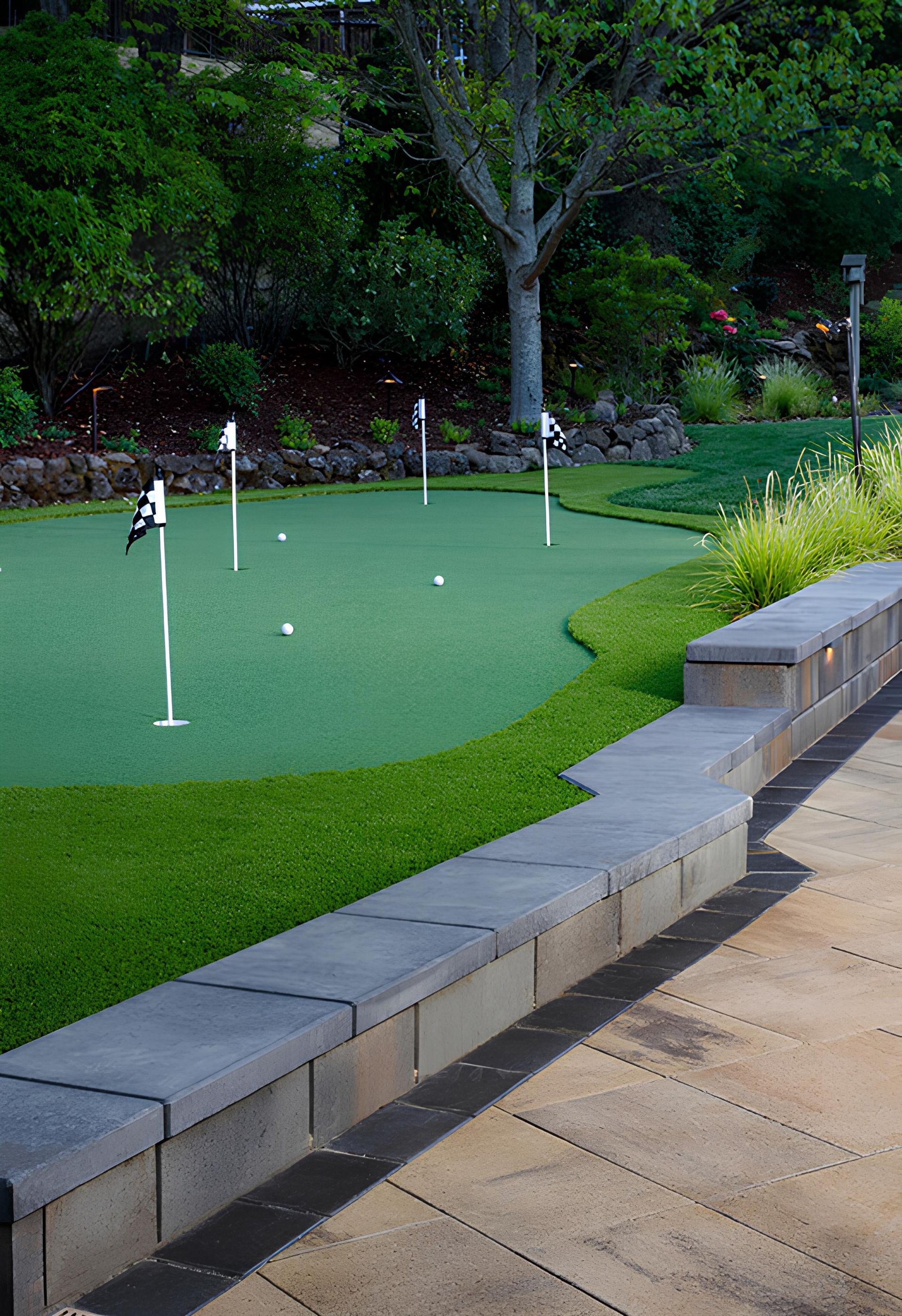 There is a putting green in the middle of a park.