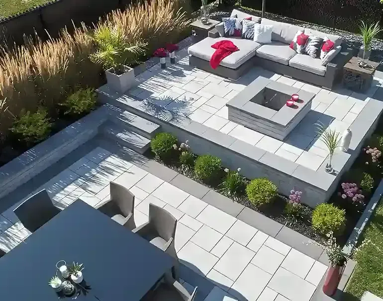 An aerial view of a patio with furniture and a fire pit
