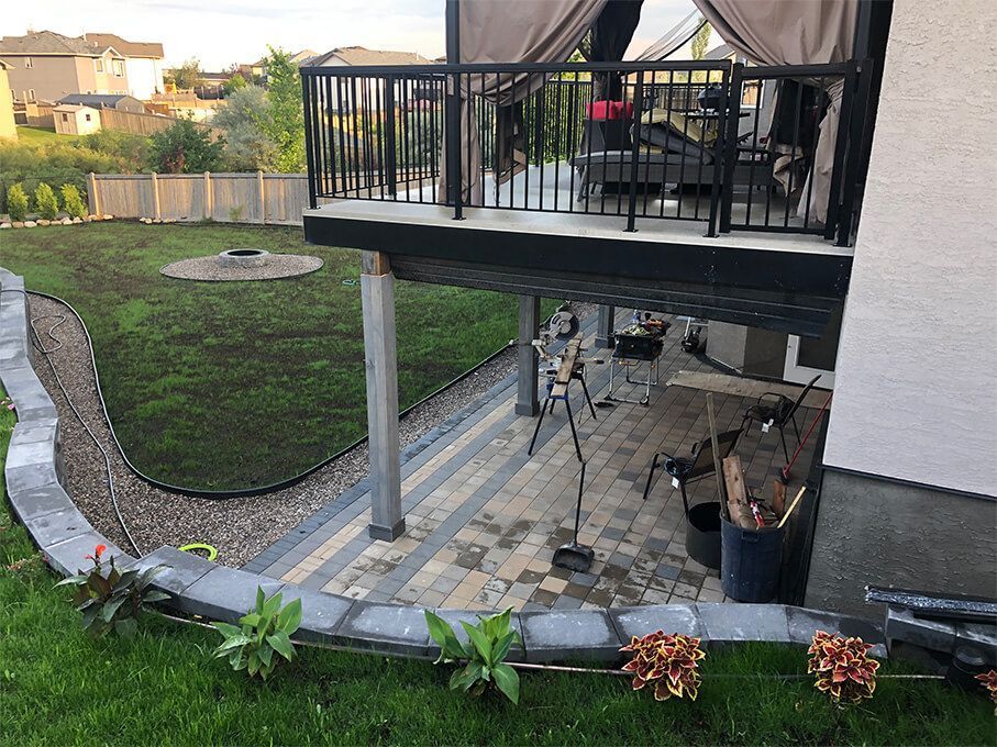 A house with a patio and a balcony in the backyard.