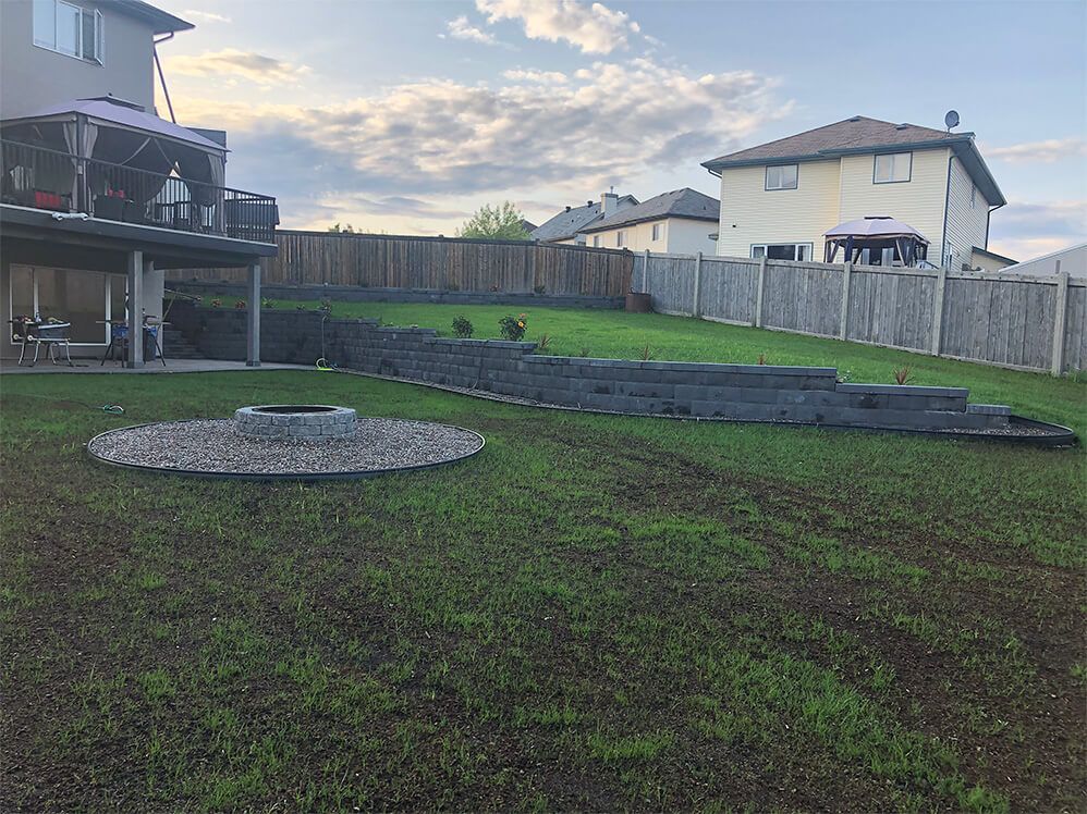 There is a fire pit in the middle of the backyard.