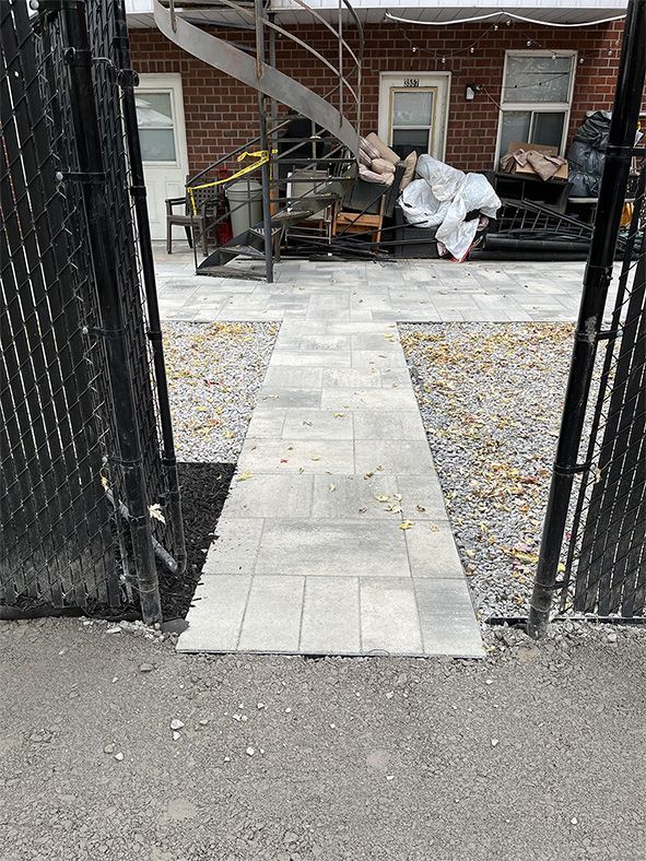 A brick building with a staircase and a walkway leading to it.