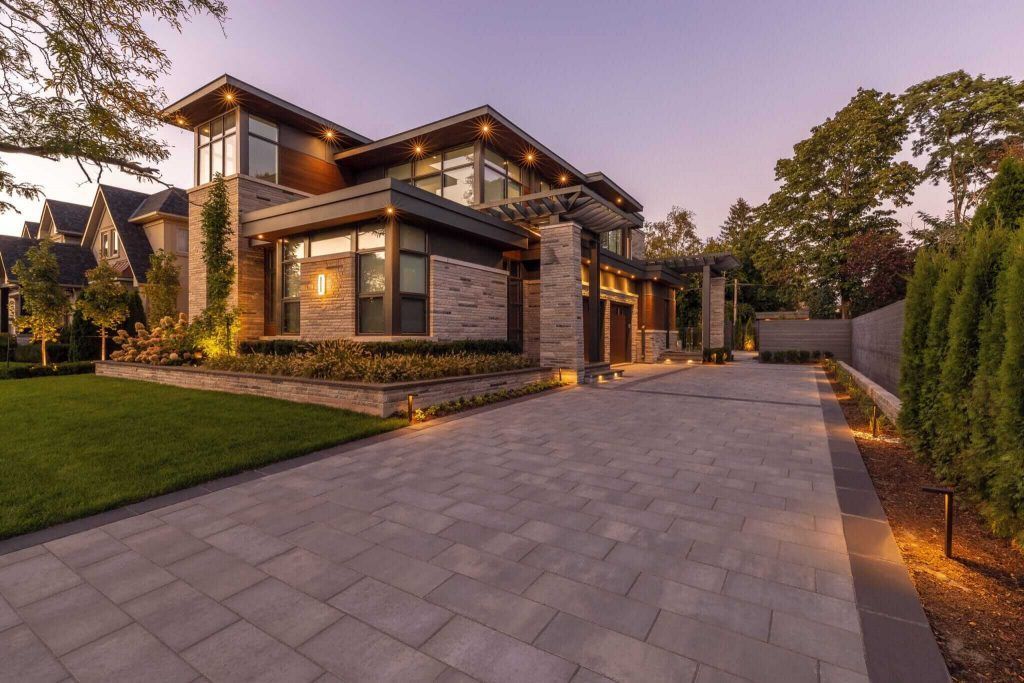 A large house with a large driveway in front of it.