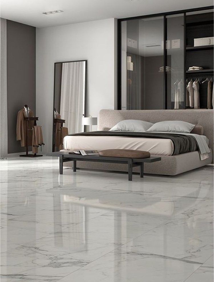 Luxurious bedroom with marble floors, a bed, and a large wardrobe.