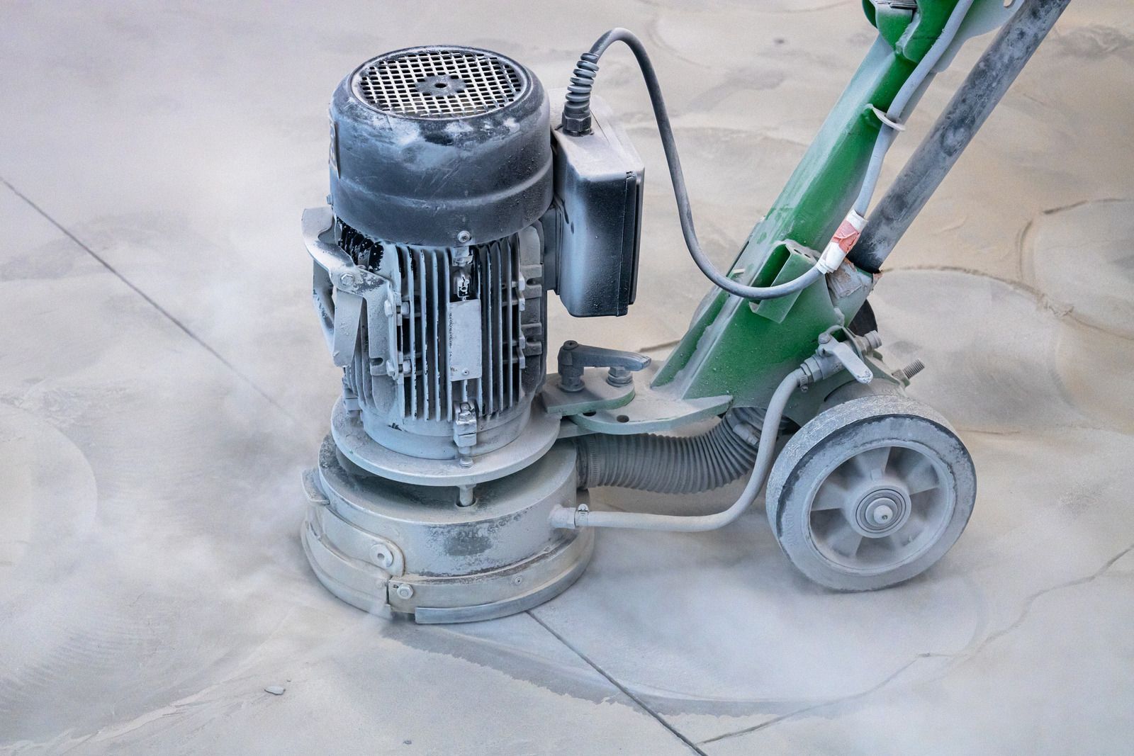 Polished speckled concrete floor in a room with a window and a door.