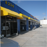 Exterior of a blue and yellow commercial building; the number 3220 is visible.