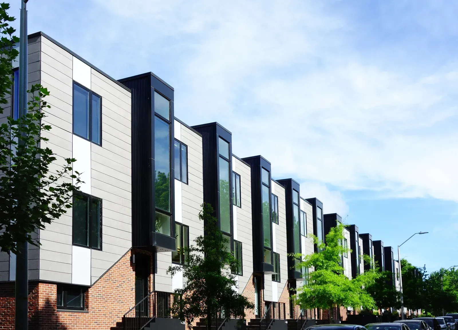 A row of apartment buildings with stairs leading up to them