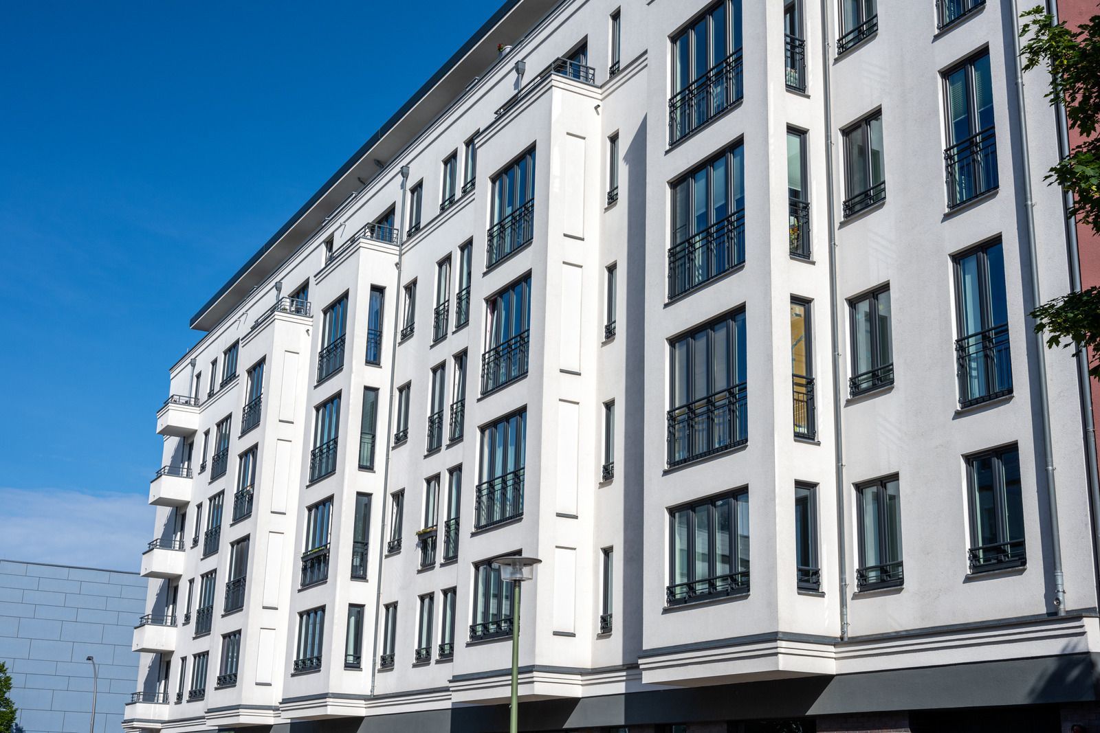 A large white building with a lot of windows on a sunny day.