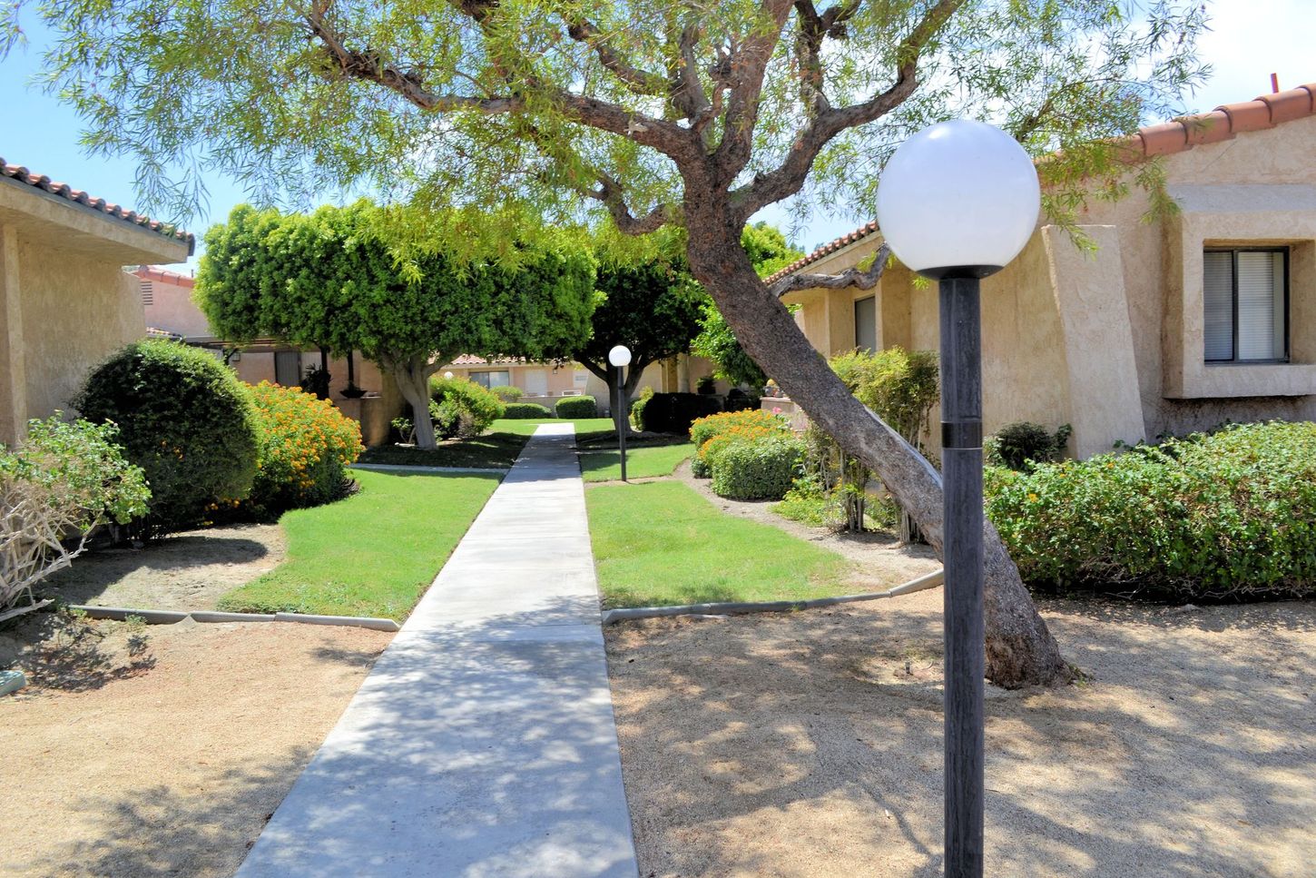 A walkway leading to a building with a lamp post in the foreground