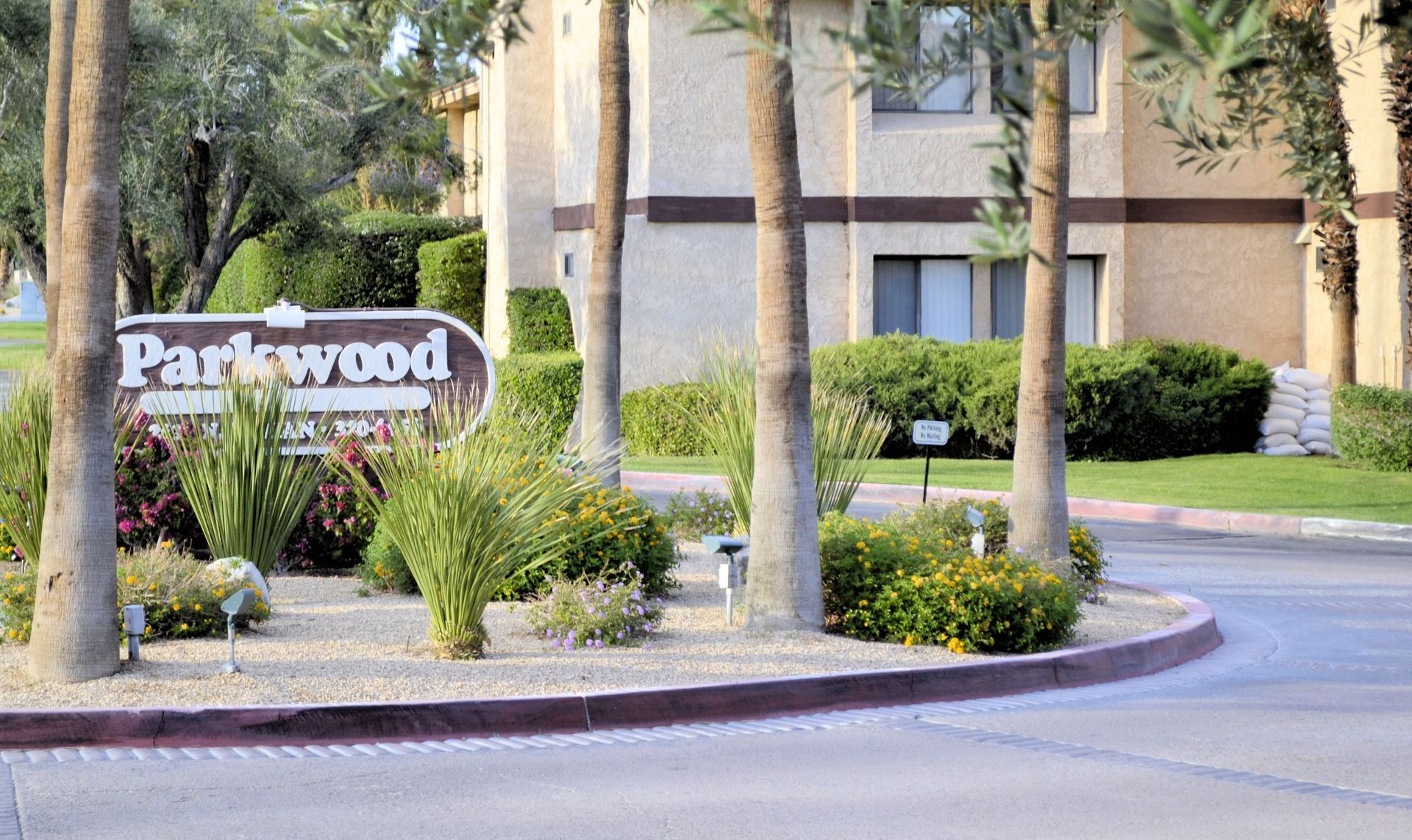 A Parkwood sign is in front of a building