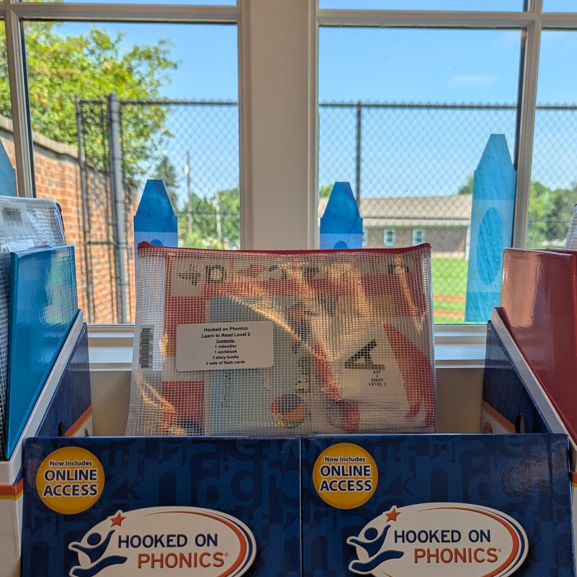 A transparent phonics kit bag, including books and a CD.