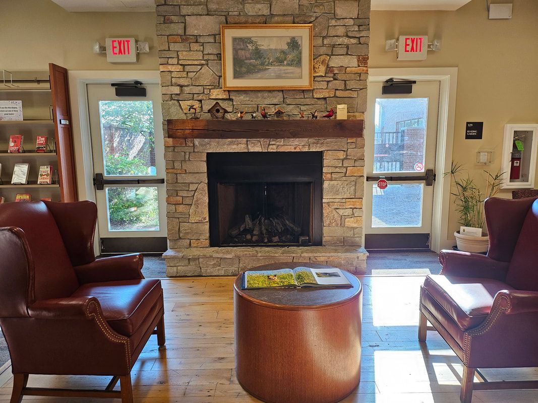A fireplace between two leather armchairs.