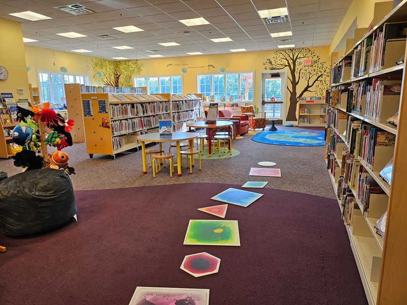 A children's area in a library with colorful squares on the floor