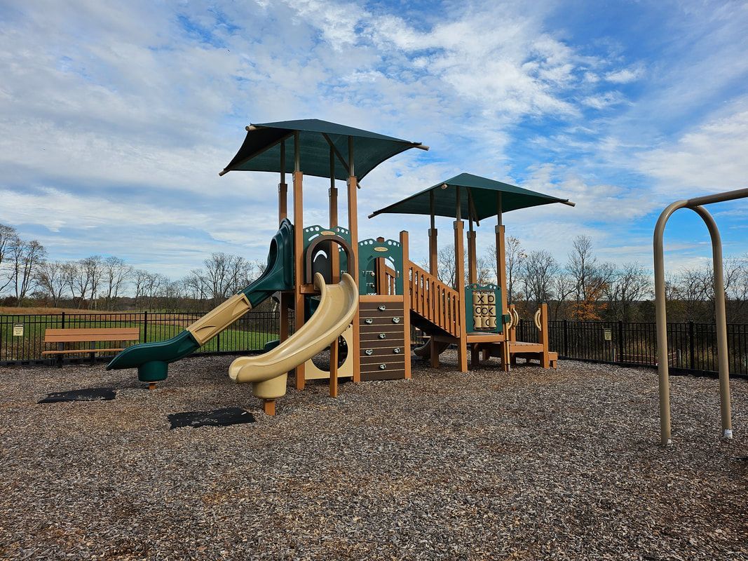 A playground with a slide and a swing set