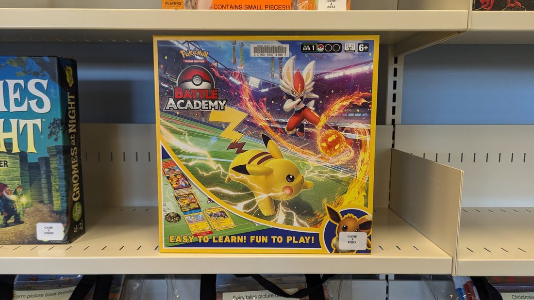 A game called pokemon battle academy sits on a shelf