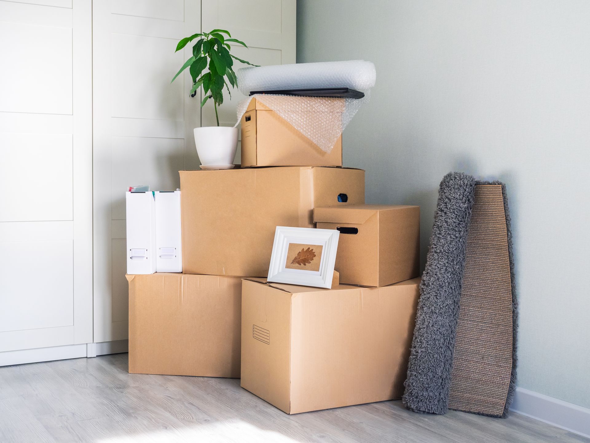 A bunch of cardboard boxes are stacked on top of each other in a room.