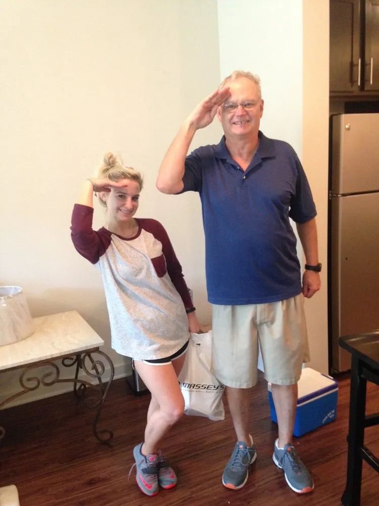 A man and a woman are standing next to each other in a living room.