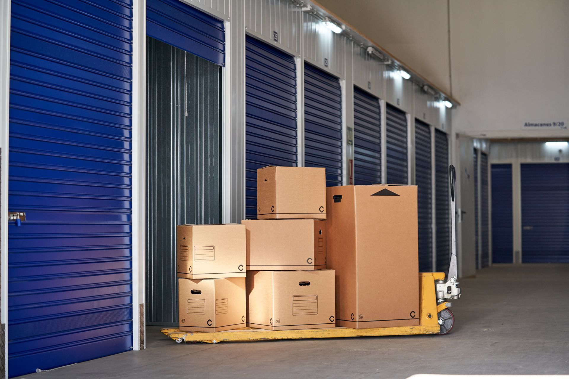 A bunch of cardboard boxes are stacked on top of each other in a warehouse.