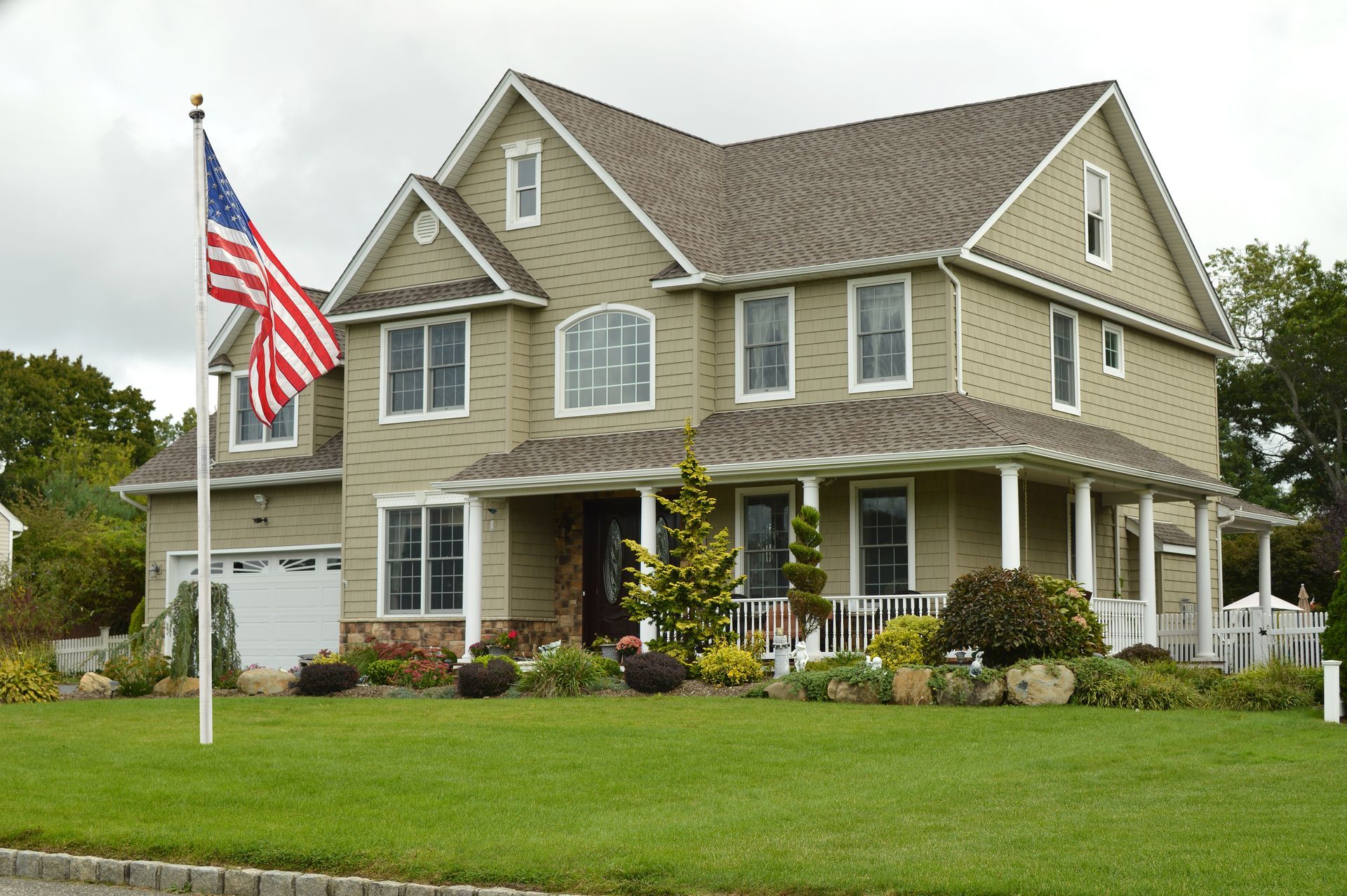 A large house with an american flag in front of it