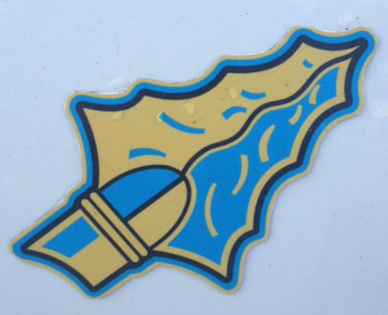 Blue and gold stylized leaf-shaped design with a bullet shape.
