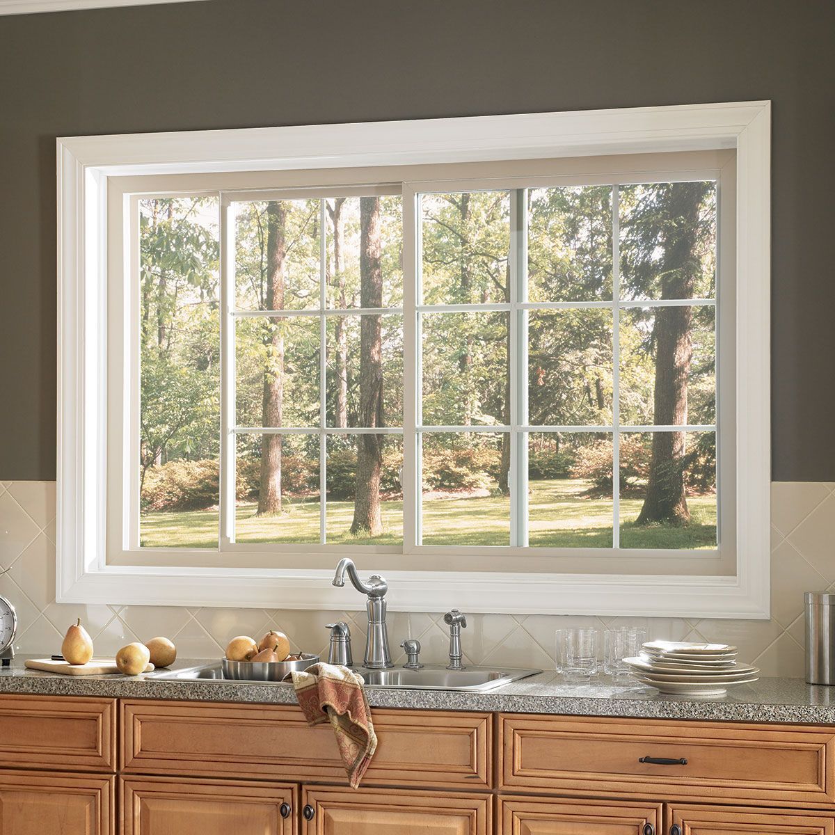 A kitchen with a large window and a sink