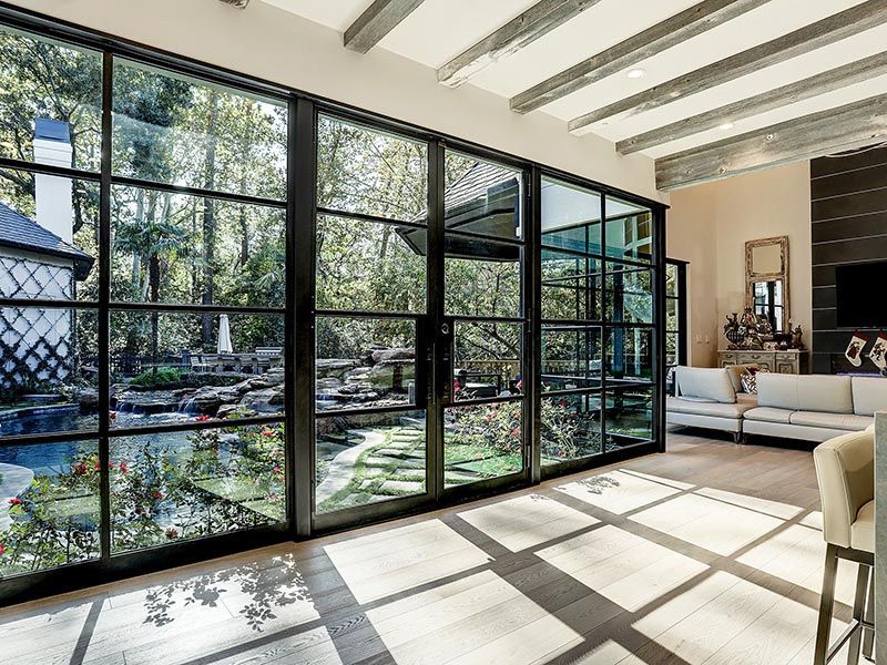 A living room with a lot of windows and a couch.