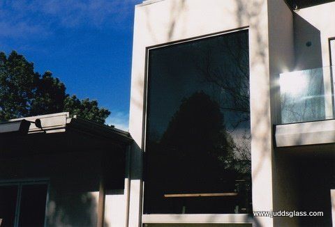 A large window on the side of a building says www.codglass.com