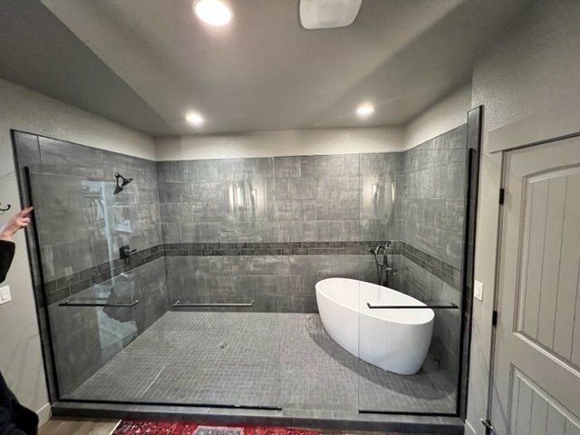 A bathroom with a bathtub and a walk in shower.