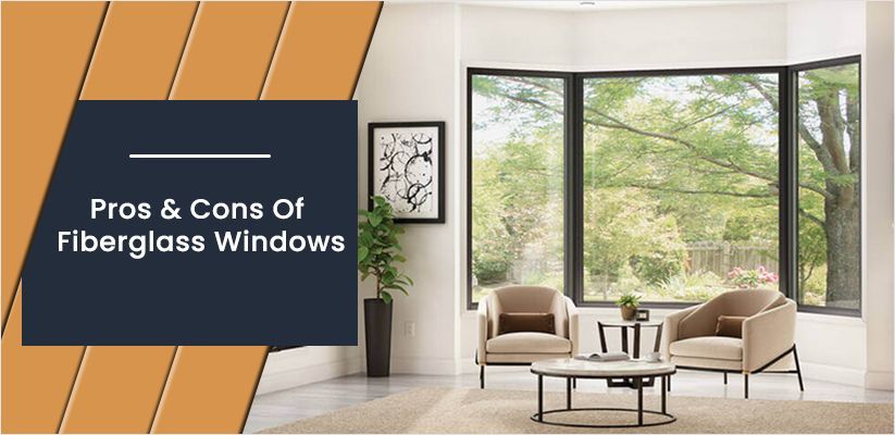 A living room with a lot of windows and a table and chairs.