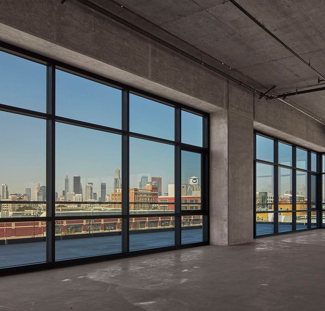 An empty room with lots of windows and a view of the city using low e glass