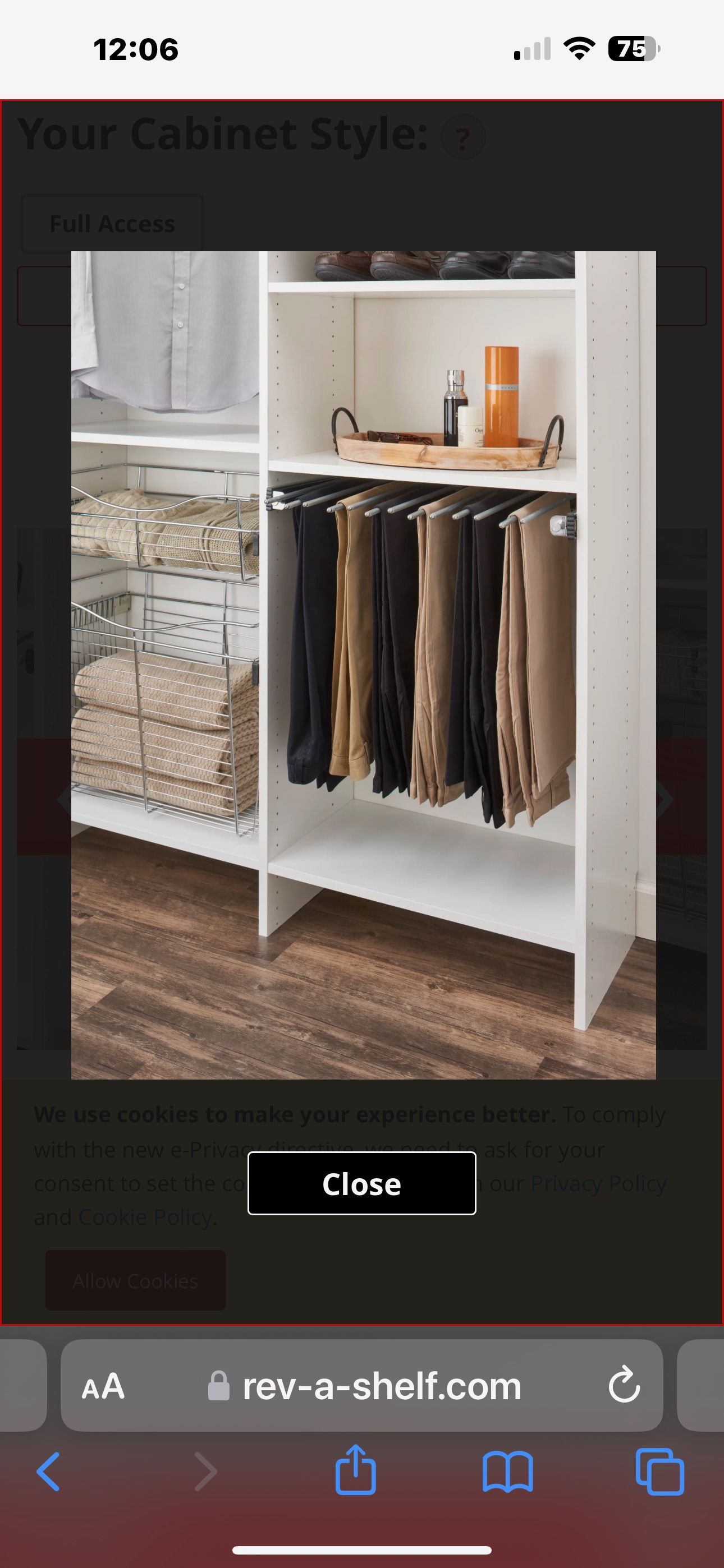 White closet organizer with pants hanging, a tray with items on a shelf, and stacked folded items.