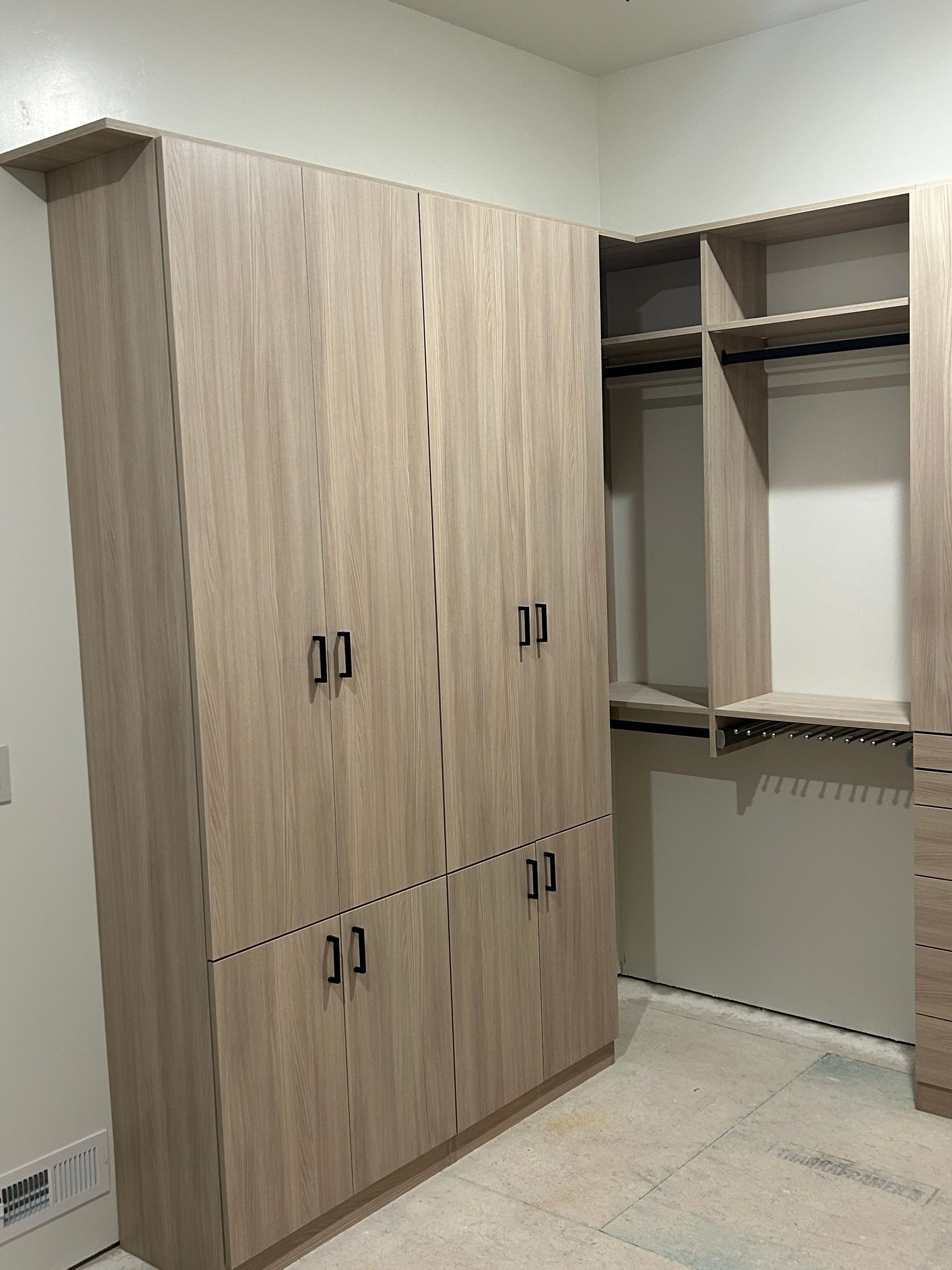Wooden wardrobe and closet with hanging rods in a room.